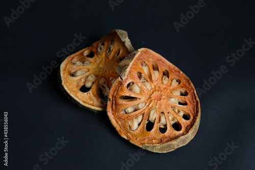 Dry Bael Fruit isolate on black background.

Dry Bael Fruit for making herbal juice.

Properties that add freshness has a delicate fragrance.