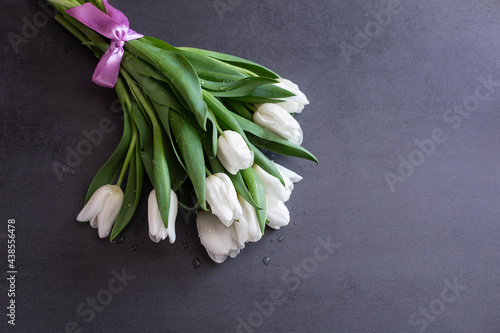 bouquet of delicate tulips on a dark background.
