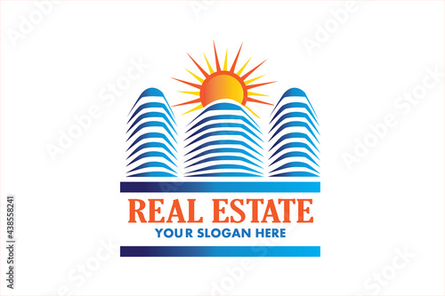 Modern blue buildings and sun real estate id business card icon logo vector image graphic design illustration