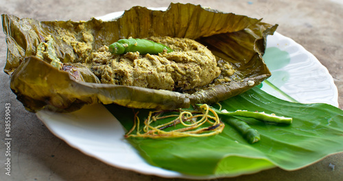 steamed Hilsa or Ilish fish(sea food) with mustard and chilli,served on banana leaf 