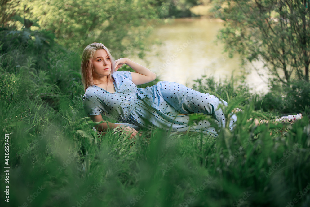 Girls laying in grass near lake. Summer, nature Girls laying in grass near lake. Summer, nature