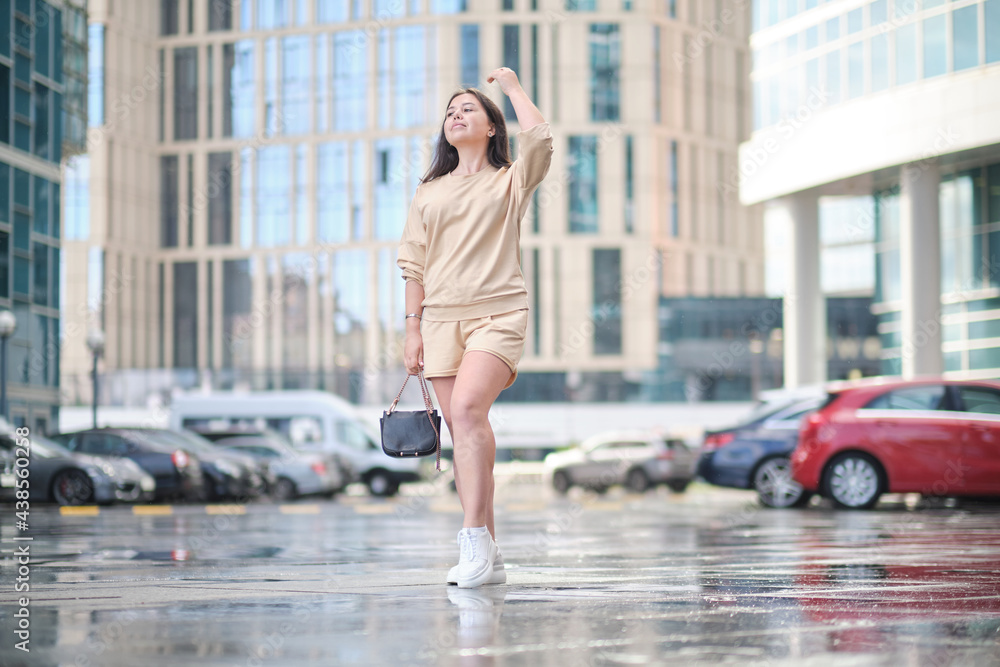 portrait of a young confident woman walking in a modern city portrait of a young confident woman walking in a modern city