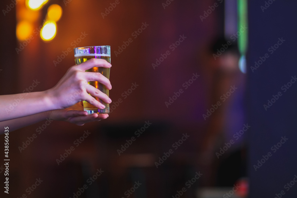 The woman sat in the pub and held a glass of beer in her hand to drink in celebration of the store's opening after the pub was shut down during the corona virus outbreak,according to government orders The woman sat in the pub and held a glass of beer in her hand to drink in celebration of the store's opening after the pub was shut down during the corona virus outbreak,according to government orders