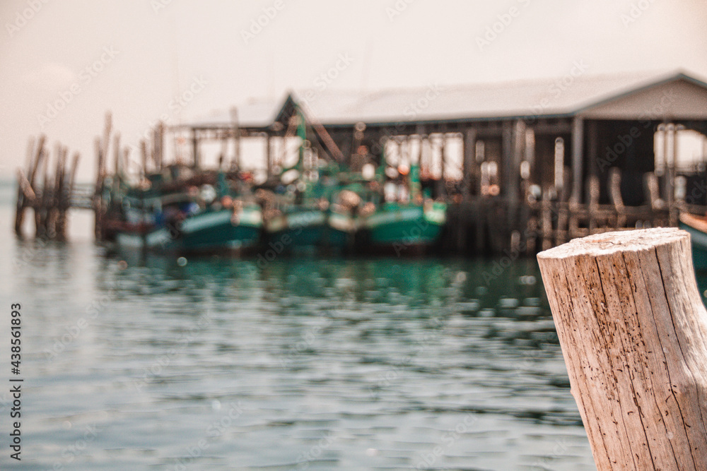 Scenic view of traditional Khmer fishing boats moored at the harbor of Koh Sdach Island in Cambodia that is blurred on purpose for background effect