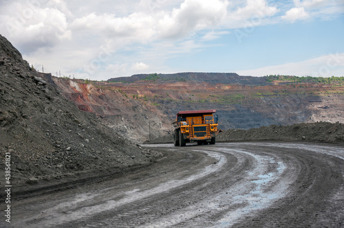 open cast dump truck drives alone industrial area of iron ore quarry © sashagrunge