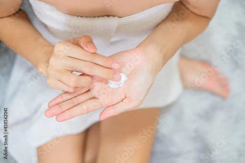 Woman applying natural cream  Woman moisturizing her hand with cosmetic cream  Spa and Manicure concept.