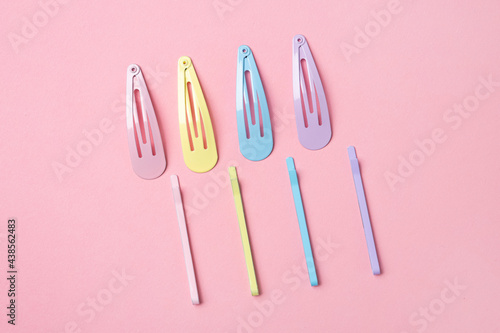 Group of colorful pastel color Hair Clips on Pink Background, Styled Shot,modern accessories for hair