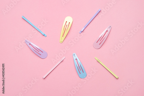 Group of colorful pastel color Hair Clips on Pink Background, Styled Shot,modern accessories for hair photo