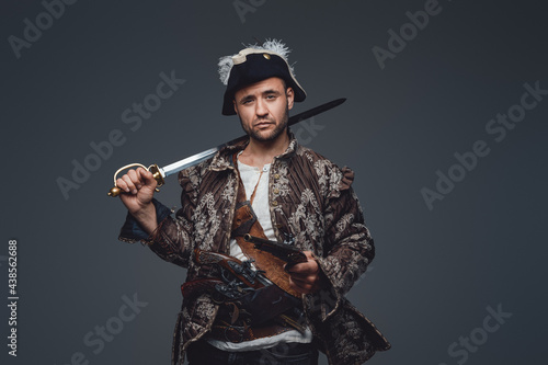 Medieval corsair pirate with saber and pistol photo