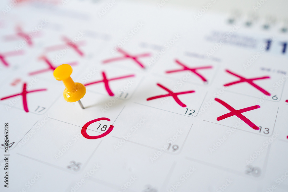 Calendar with yellow pins on the 18th. Yellow pins are the dates of the calendar or planner. Calendar with yellow pins on the 18th. Yellow pins are the dates of the calendar or planner.