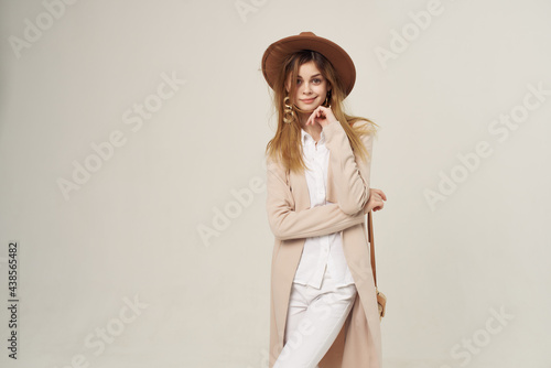 pretty woman in hat fashion posing modern style light background
