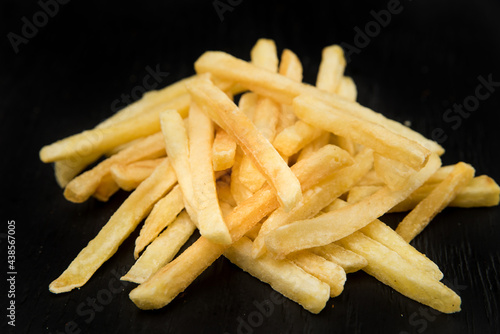 French fries on black background