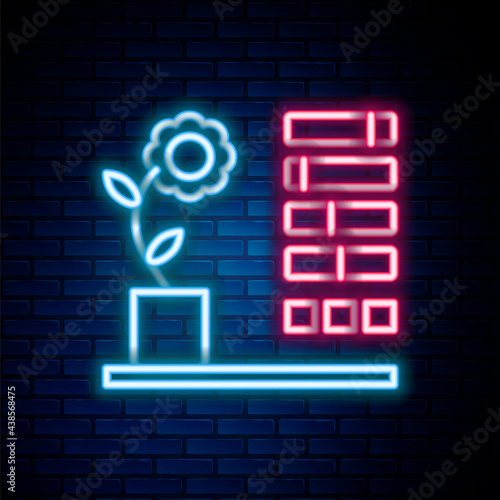 Glowing neon line Flower status icon isolated on brick wall background. Colorful outline concept. Vector