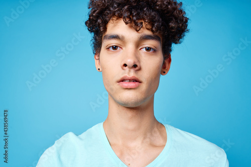 guy in blue t-shirt curly hair cropped view isolated background