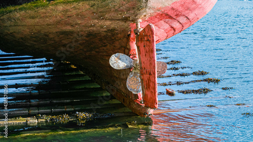 Fishing boats moored in a small harbour in the town of Dartmouth in Devon, UK. Southwest England, British sea life. 