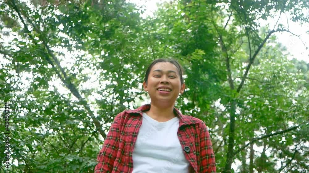 Portrait of a happy young woman looking at camera and smiling in a nature park . Travel and happiness concept. Portrait of a happy young woman looking at camera and smiling in a nature park . Travel and happiness concept.