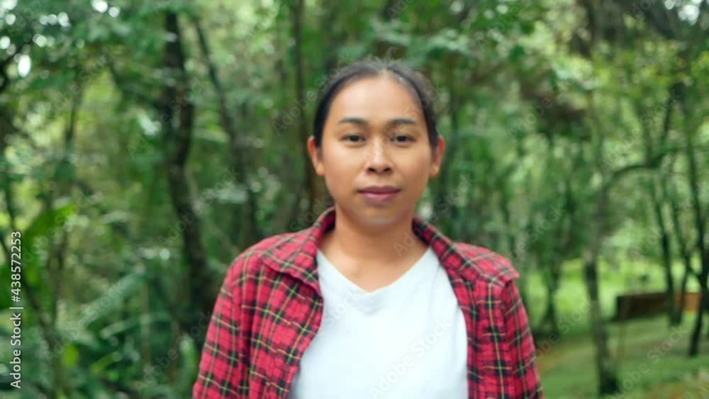 Portrait of a happy young woman looking at camera and smiling in a nature park . Travel and happiness concept. Portrait of a happy young woman looking at camera and smiling in a nature park . Travel and happiness concept.