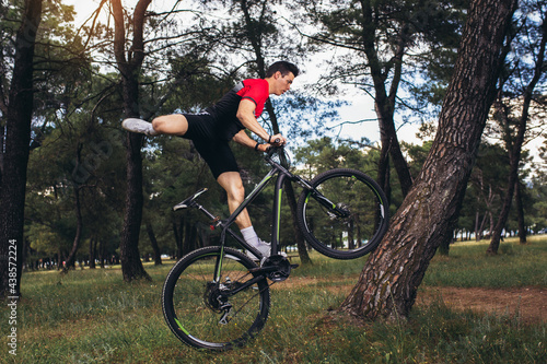 Mountain bike cyclist riding trail in forestt.Healthy lifestyle and outdoors adventure. photo