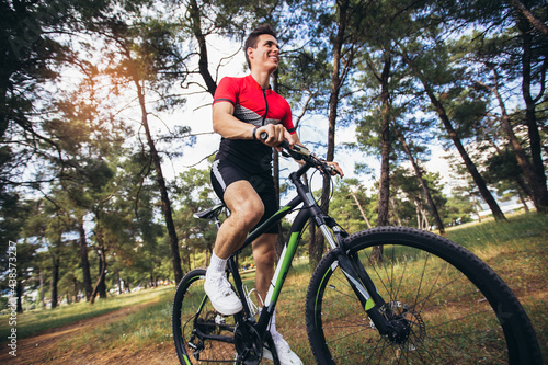 Mountain bike cyclist riding trail in forestt.Healthy lifestyle and outdoors adventure. photo