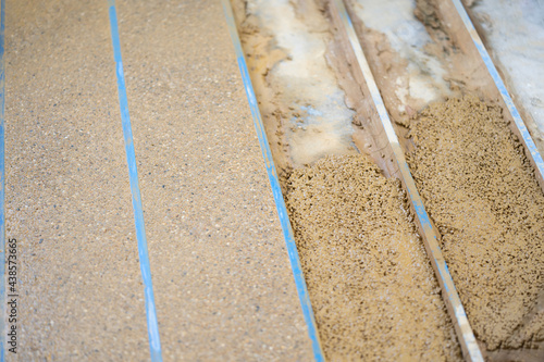 Close up to the orange stone floor in construction process, it compairs between complete and not complete section and zone. photo