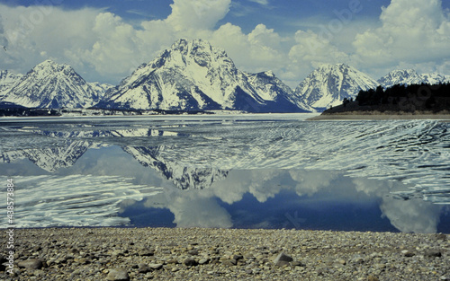 mirror reflection of the Tetons, WYO, USA in the frozen  lake in winter photo