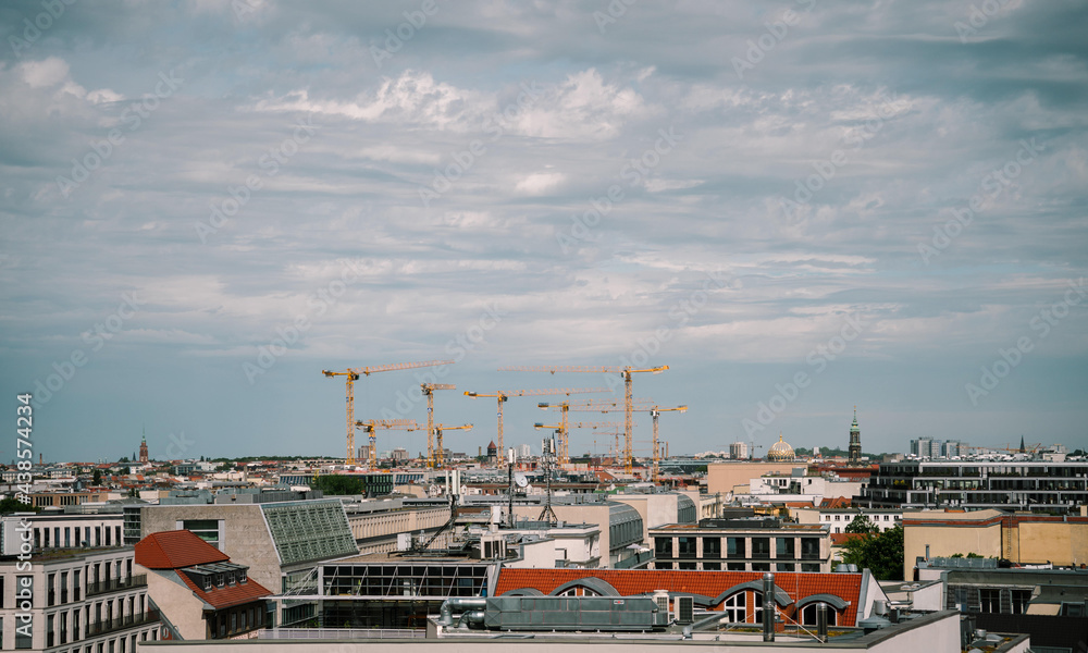 Fototapeta premium construction site with many cranes in summer