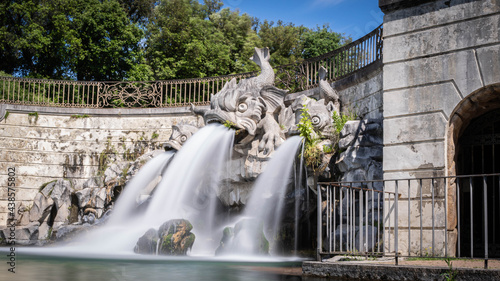 Royal Palace of (Reggia di) Caserta - The large basin of the park's artificial lake. The beautiful fountain with water coming out of the mouths of monstrous fish statues. Fountain of the three dolphin