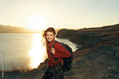 cheerful woman hiker with a backpack outdoors freedom travel vacation