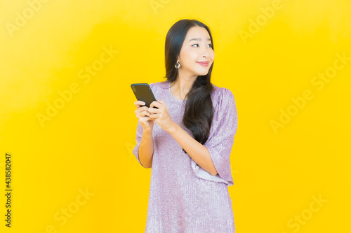 Portrait beautiful young asian woman smile with smart mobile phone