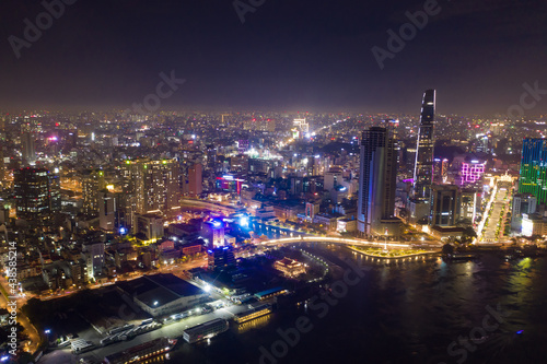 Ho Chi Minh City skyline and the Saigon River. Amazing colorful night view of skyscraper and other modern buildings at downtown. Ho Chi Minh City is a popular tourist destination of Vietnam.