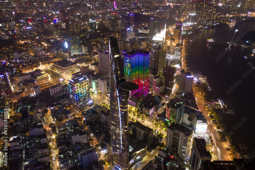 Ho Chi Minh City skyline and the Saigon River. Amazing colorful night view of skyscraper and other modern buildings at downtown. Ho Chi Minh City is a popular tourist destination of Vietnam. Ho Chi Minh City skyline and the Saigon River. Amazing colorful night view of skyscraper and other modern buildings at downtown. Ho Chi Minh City is a popular tourist destination of Vietnam.