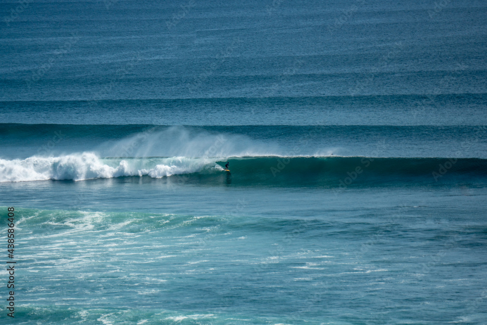 Surfer on perfect blue wave, in the barrel, clean water, Indian Ocean Surfer on perfect blue wave, in the barrel, clean water, Indian Ocean
