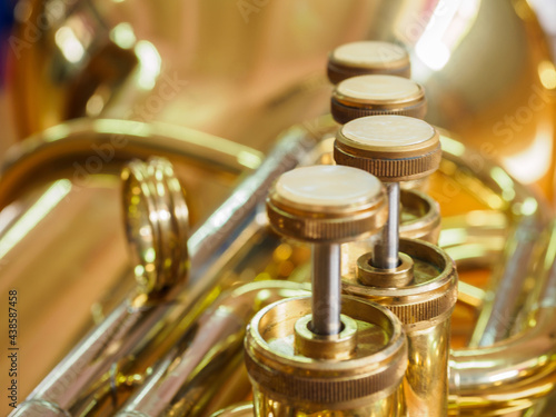close-up shot of piston value tuba, brass instrument piston value 