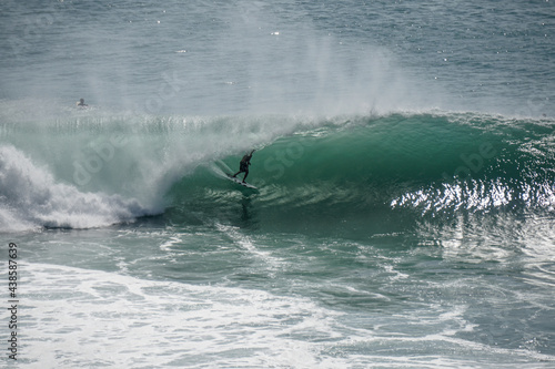 Surfer on perfect blue wave, in the barrel, clean water, Indian Ocean