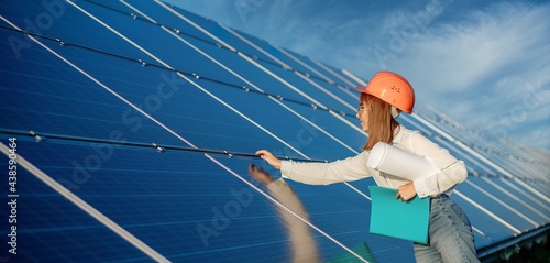Businesswomen working on checking equipment at solar power plant with tablet checklist, woman working on outdoor at solar power plant