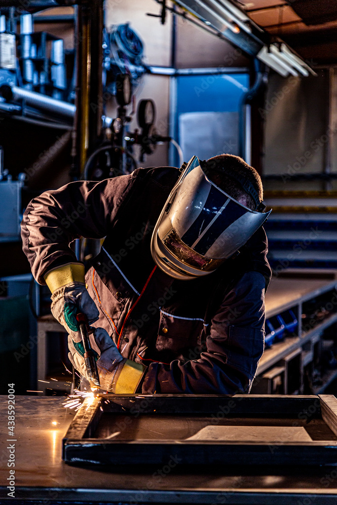 A welder welding in factory A welder welding in factory