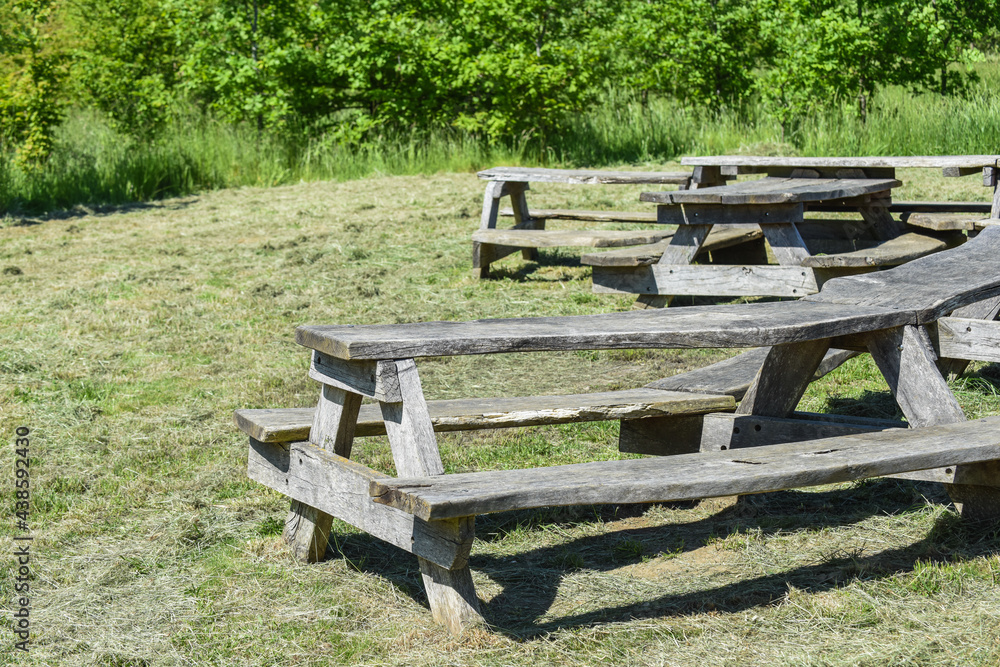 Large picnic table and bench in a sunny public park