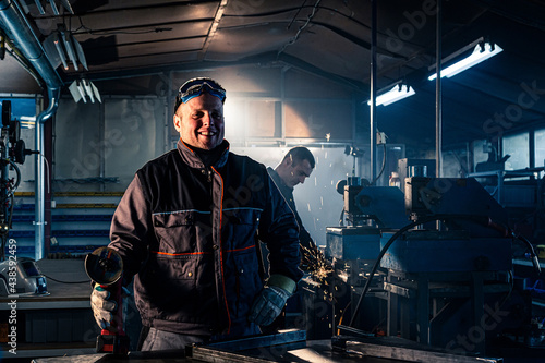 Portrait of the grinding handyman posing in the workshop