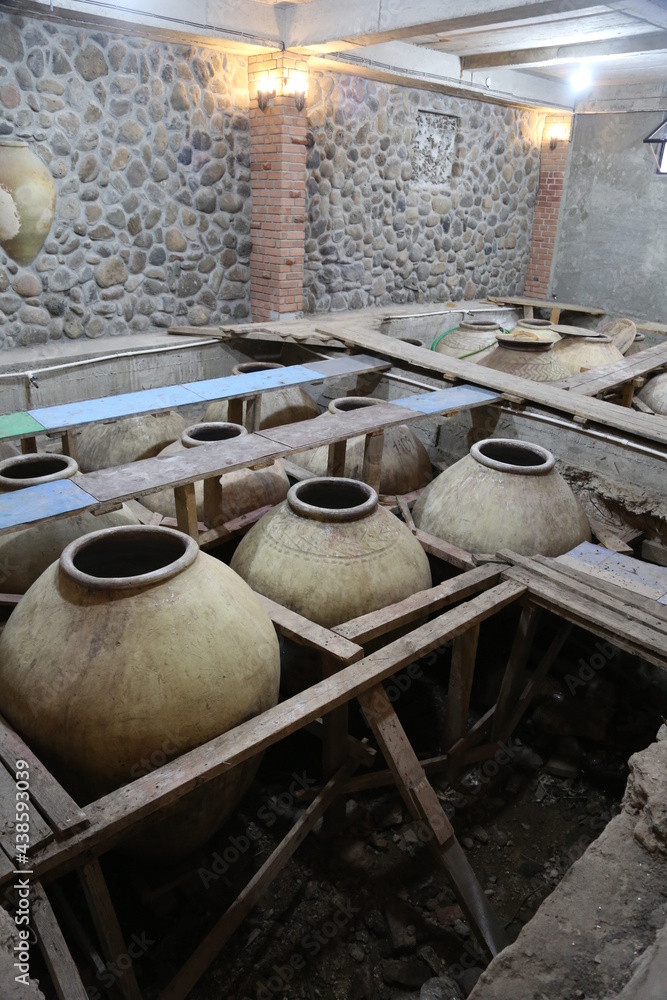 Old ceramics wine jars called kvevri at the wine factory in Georgia. Traditional ceramic pottery barrel for wine. Old ceramics wine jars called kvevri at the wine factory in Georgia. Traditional ceramic pottery barrel for wine.