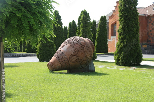 Old ceramics wine jars called kvevri at the wine factory in Georgia. Traditional ceramic pottery barrel for wine. photo