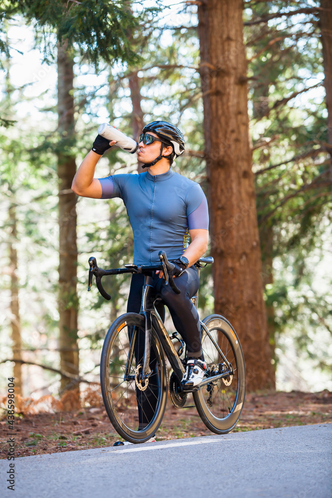 Cyclist drinking water during a riding break