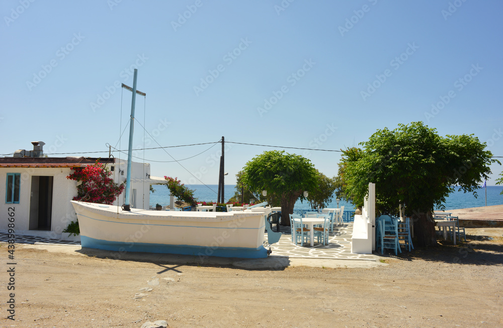 Rhodes Island, Kiotari small greek restaurant with sea view and a old boat