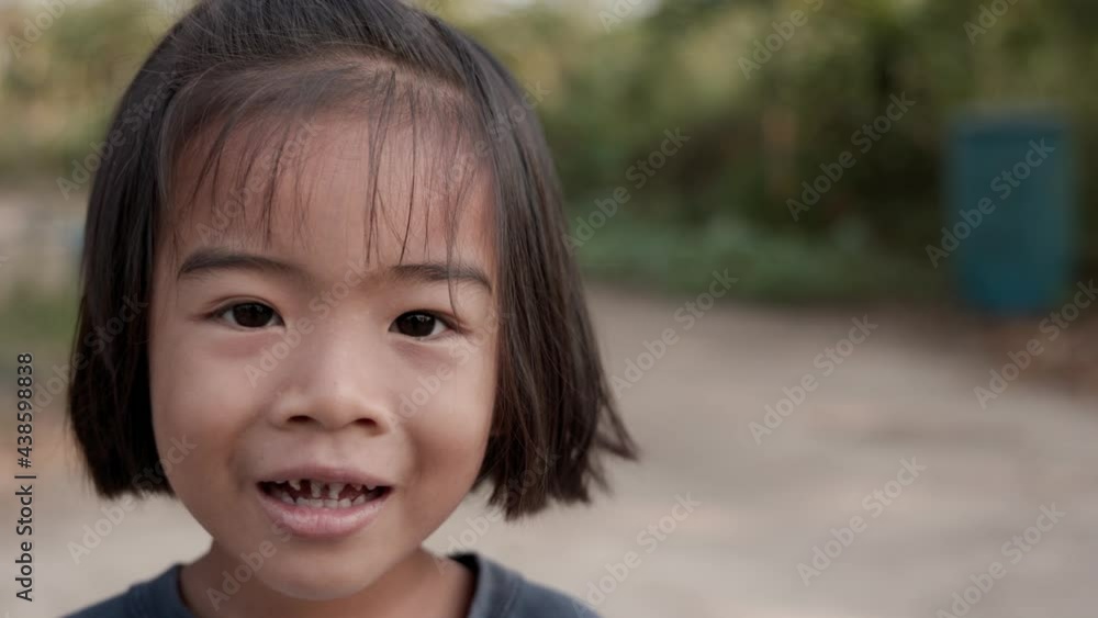 The cute little Asian girl smiled happily and was holding a little kitten. The cute little Asian girl smiled happily and was holding a little kitten.