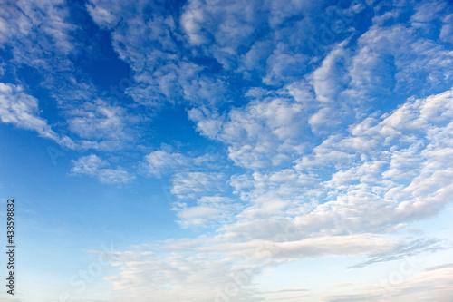 fluffy white clouds in blue sky background