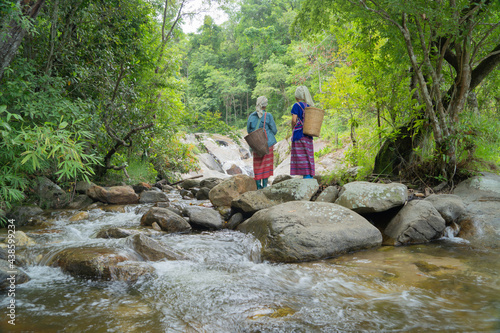 Karen tribe women with traditional dress at Sapun Waterfall. Nature of Nan in natural park, Thailand in travel trip on holiday and vacation, tourist attraction. Nature landscape. People lifestyle. photo