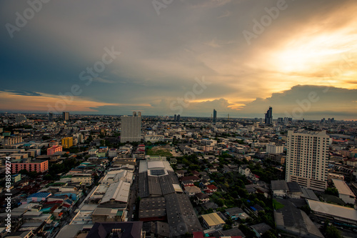 Highly blurred background from the residence,with a panoramic view of the city(condominium,office,home offices,houses,football fields,bridges across the river) and colorful colors from the evening sky