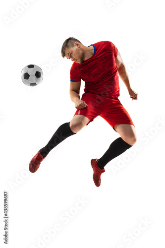 Powerful, flying above the field. Young football, soccer player in action, motion isolated on white background . © master1305