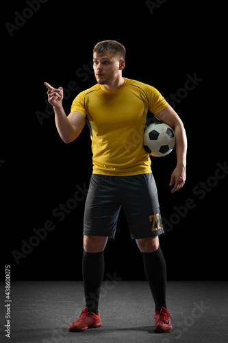 The male unhappy soccer or football player arguing with a judge. The professional soccer football and human emotions concept.