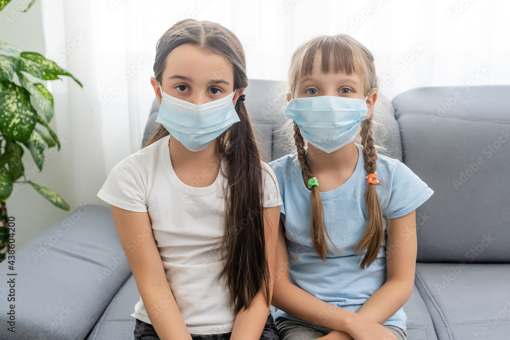 Two little kid girls in sterile face mask. Epidemic pandemic coronavirus 2019-ncov sars covid-19 flu virus concept.
