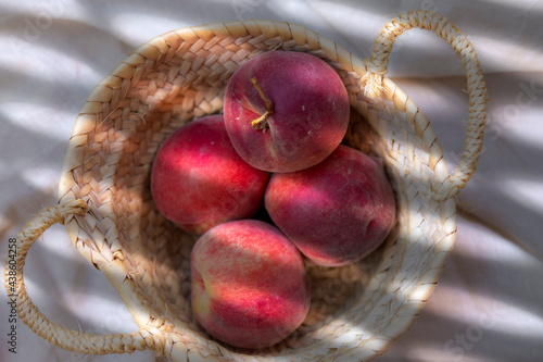 Wallpaper Mural Ripe peaches in basket on light background Torontodigital.ca